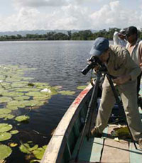 Image of Nicholas Hellmuth photographing water lily